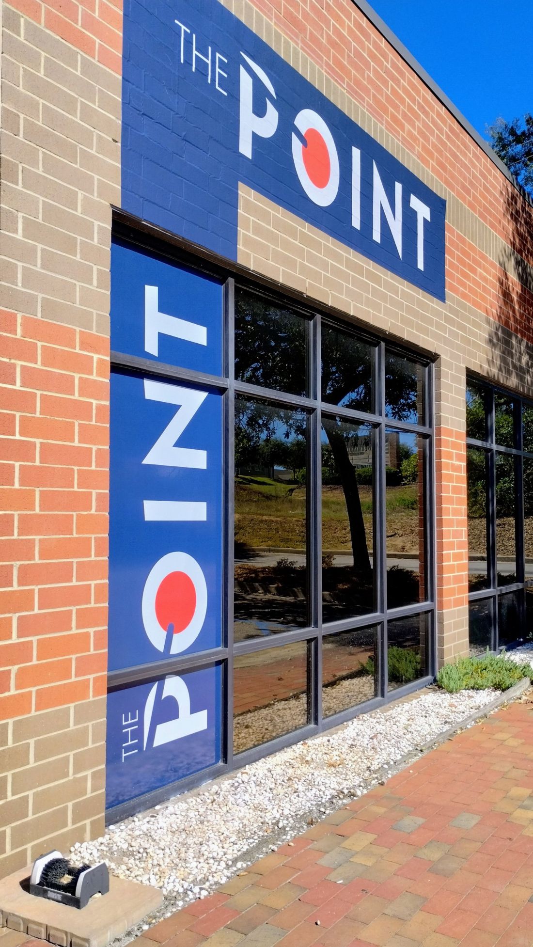 The Point podcast studio building on Sunset Blvd in West Columbia, SC, with blue signage on brick